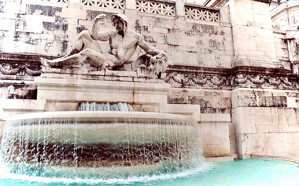 A statue of a person in a fountain

Description automatically generated