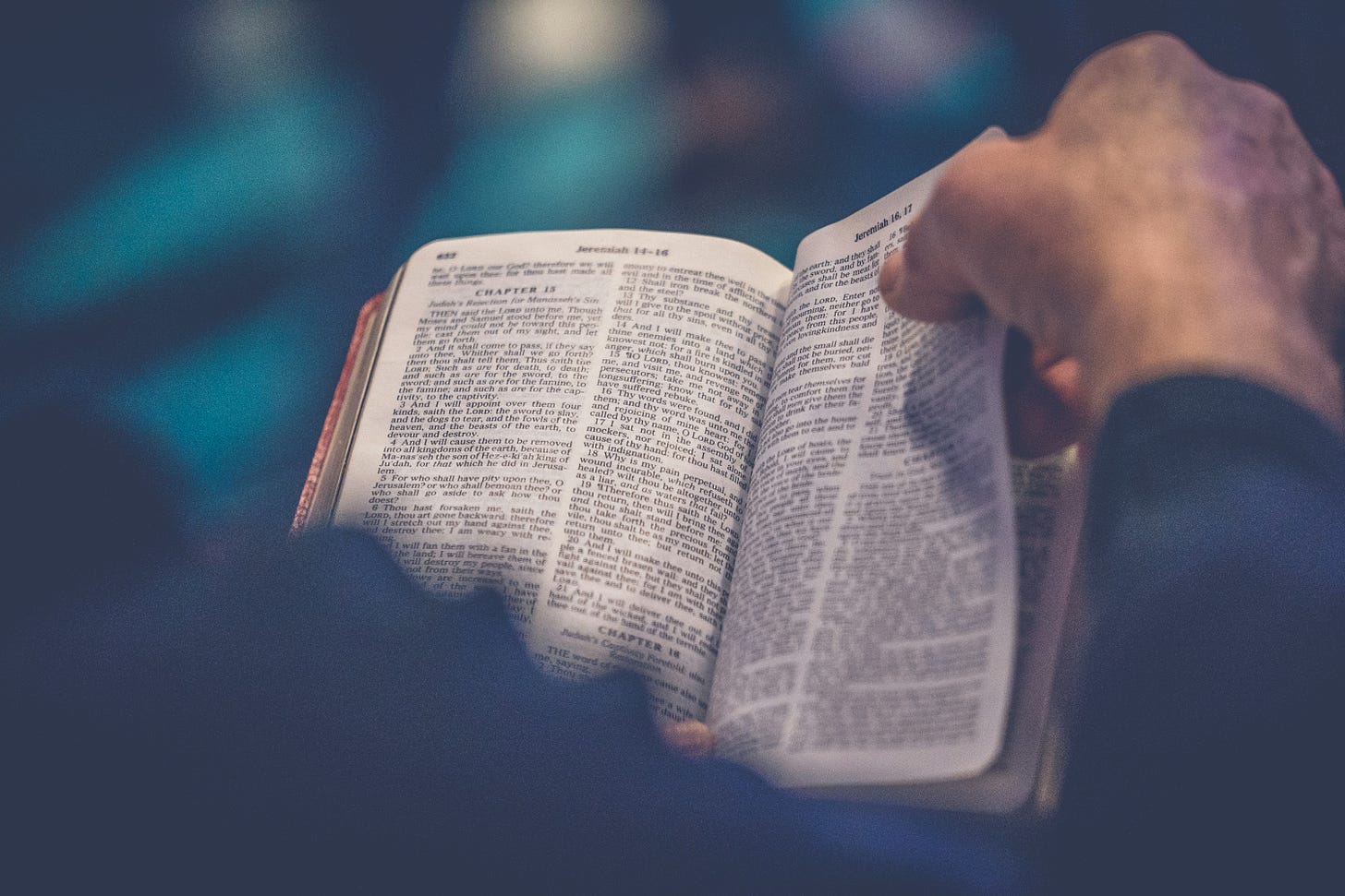 Hands opening a bible