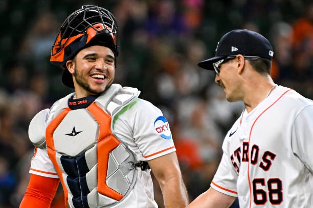 Yainer Diaz laughs with J.P. France of the Houston Astros after the end of the third inning against the Colorado Rockies at Minute Maid Park on July...