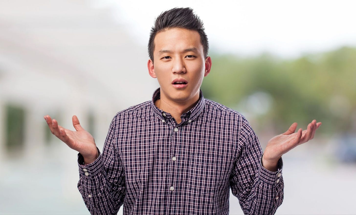Young Asian male making wtf gesture