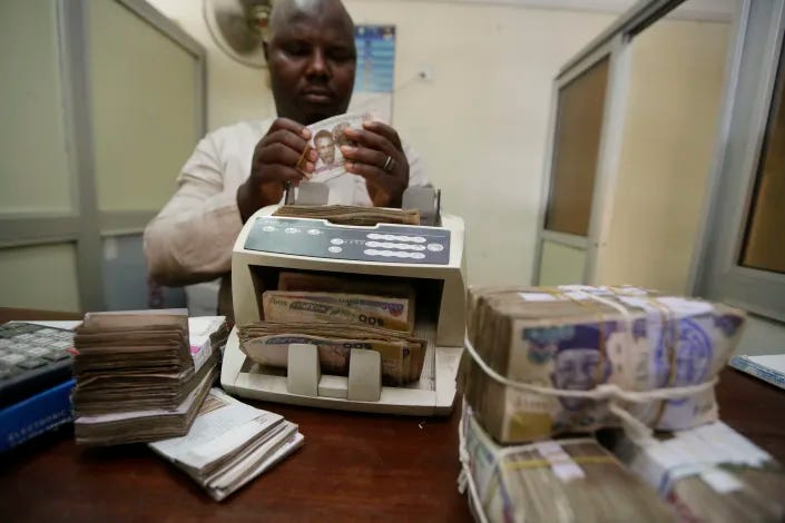 FILE - A money changer counts Nigerian naira currency at a bureau de change, in Lagos Nigeria, Oct. 20, 2015. Nigeria's push to replace the local currency notes with newly designed ones is creating an economic crisis, experts warned Monday, Jan. 30, 2023 with the limited cash in circulation hurting many people and businesses across the West African nation. (AP Photo/Sunday Alamba, File)