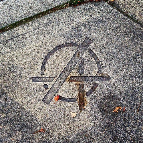 Who's putting Avengers/Anarchy symbols in the cement in such a nice way?