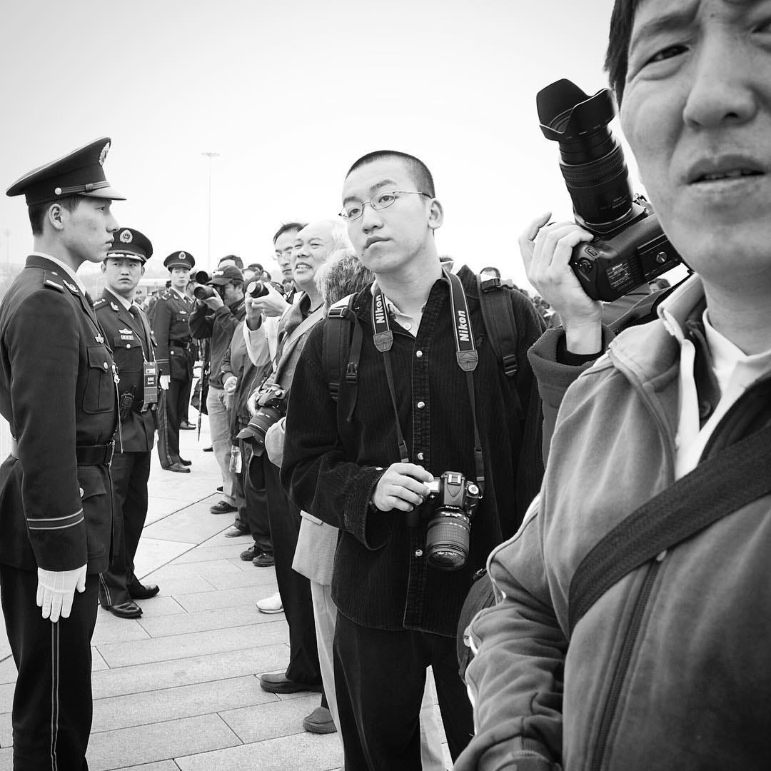 Photographers patiently waiting to capture runners participating in the Beijing Marathon. Held around October since 1981, the race begins at Tiananmen Square and finishes in the Olympic Green. Photographers patiently waiting to capture runners participating in the Beijing Marathon. Held around October since 1981, the race begins at Tiananmen Square and finishes in the Olympic Green.