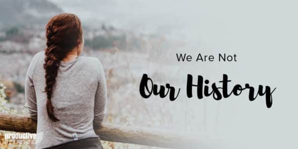 A woman with braided, dark hair, looks away from the camera at a field of daisies. Text Overlay: We Are not Our History.