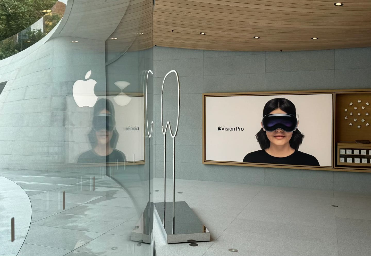 A freestanding window display and Apple Vision Pro Graphic Panel stand near the entry of Apple Jing'an.