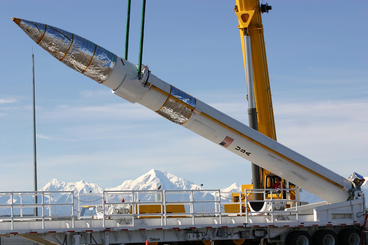 A ground-based missile interceptor is lowered into its missile silo during  a recent emplacement at