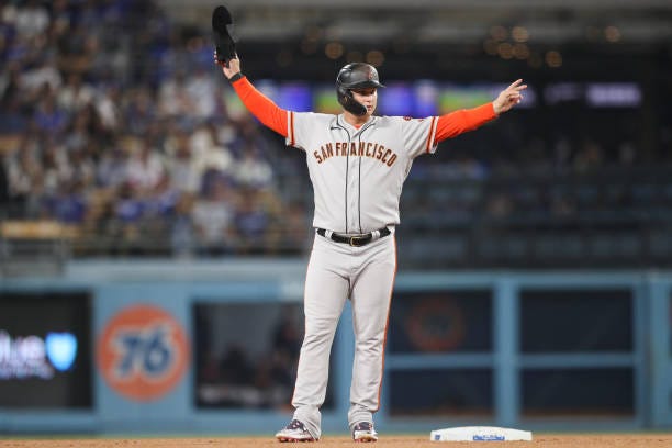 Joc Pederson of the San Francisco Giants reacts after hitting a double in the fourth inning against the Los Angeles Dodgers at Dodger Stadium on...