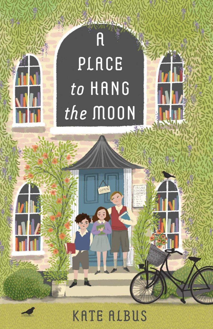 a place to hang the moon cover, 3 siblings standing in front of a library
