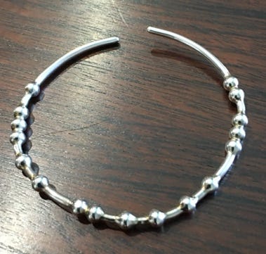 A close-up of a necklace

Description automatically generated with medium confidence