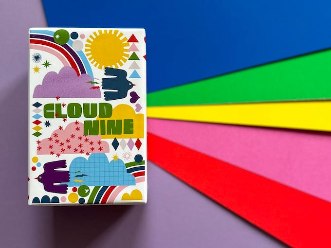 Cloud Nine prototype box on a rainbow background