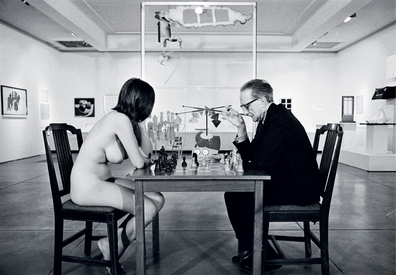 This image may contain Furniture Chair Human Person Restaurant Cafe Sitting Chess Game and Cafeteria
