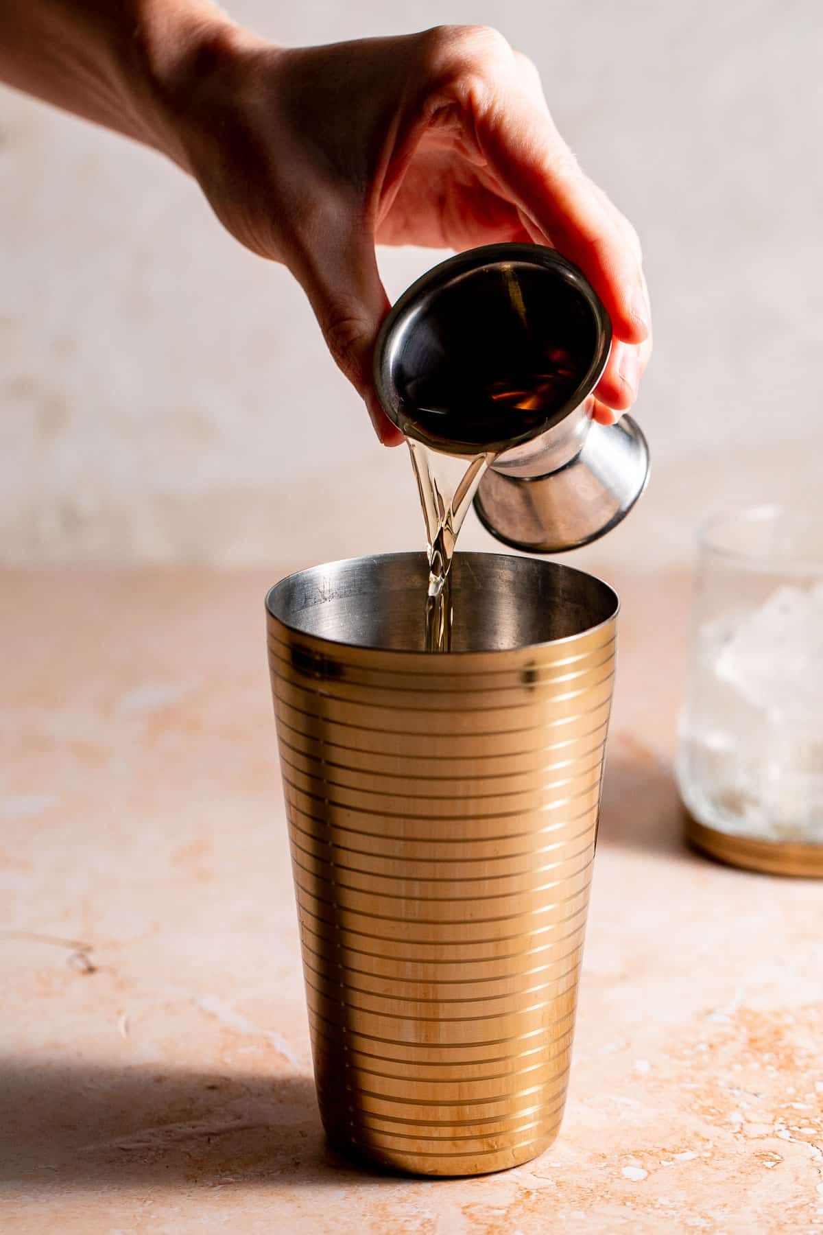 brandy pouring into a drinks shaker