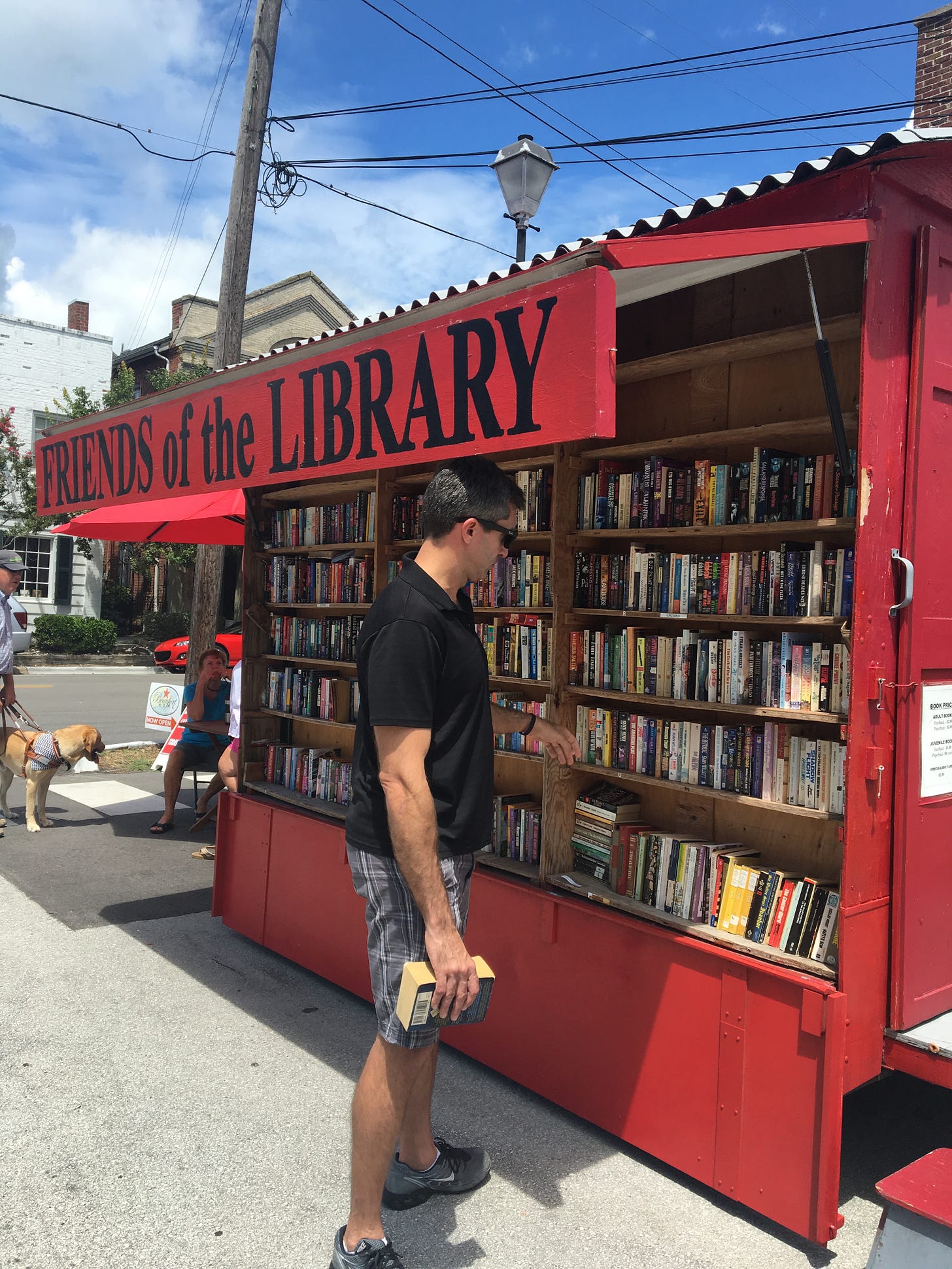 Evelyn Skye's husband buying books from a Friends of the Library kiosk in North Carolina