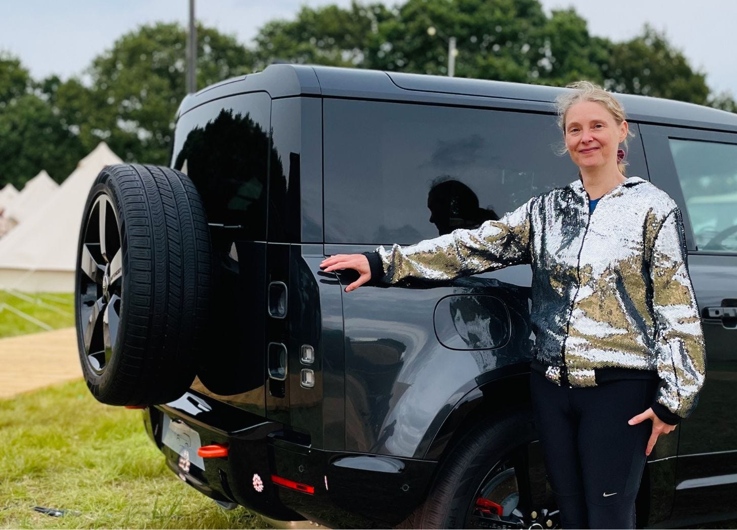 Defender X plug in hybrid with woman in sparkly top