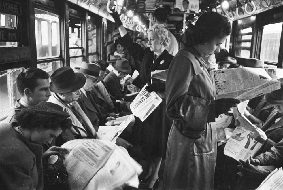 Top: A French postcard from around 1900 predicts videophone technology of the year 2000. Above: Before cell phones, humans had plenty of other media to distract them during the daily commute. This photo of passengers reading in a subway car was taken by Stanley Kubrick in 1946. Via the <a href="http://blog.mcny.org/2012/04/24/a-ride-on-the-subway-in-1946-with-stanley-kubrick/">Museum of the City of New York</a>.