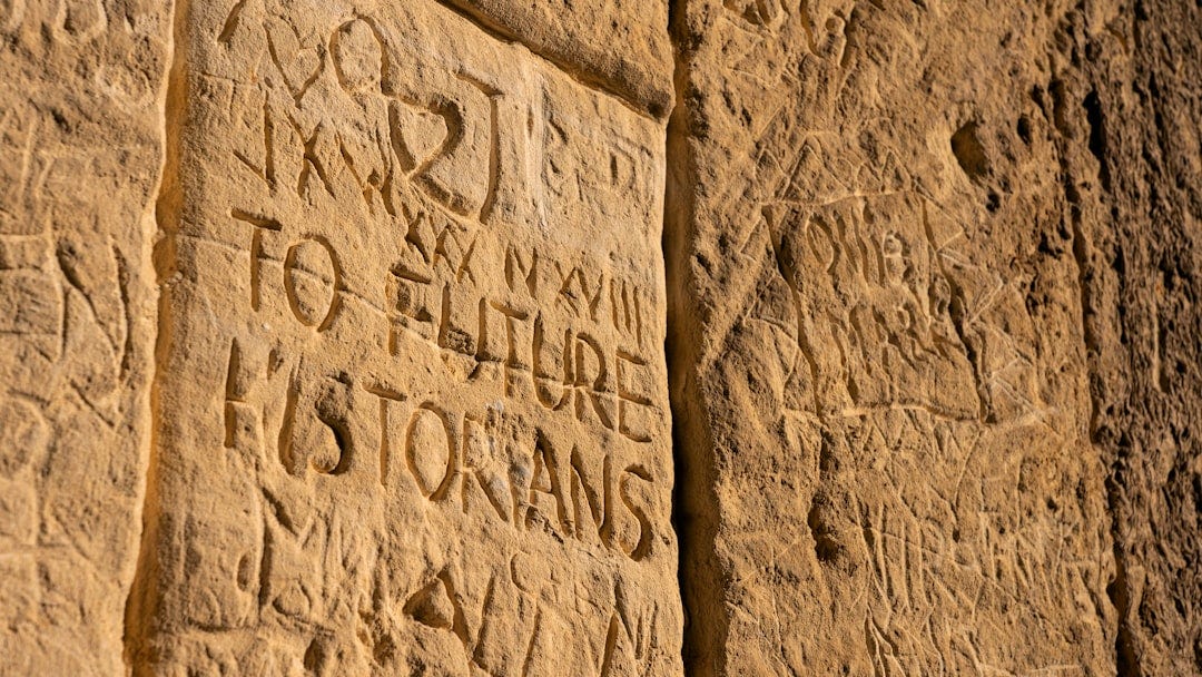 a close up of a stone wall with writing on it a close up of a stone wall with writing on it