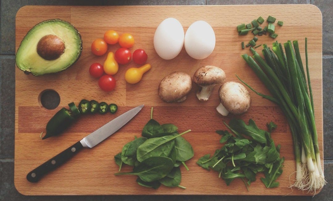 avocado, tomatoes, eggs, mushrooms, spring onions, and leaves