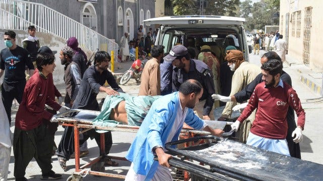 Volunteers carry a blast victim on a stretcher at a hospital in Quetta on September 29, 2023, after a suicide bombing in Mastung district. At least 25 people were killed and dozens more wounded on September 29 by a suicide bomber targeting a procession marking the birthday of Islam's Prophet Mohammed in Pakistan's southwestern Balochistan province. (Photo by AFP) (Photo by -/AFP via Getty Images)