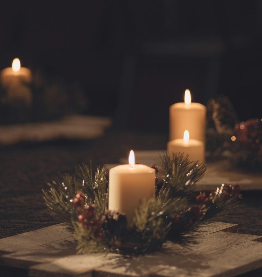 white pillar candle on brown wooden table