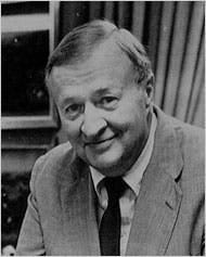 Photo of Charles Morgan, Jr. in a suit, sitting down