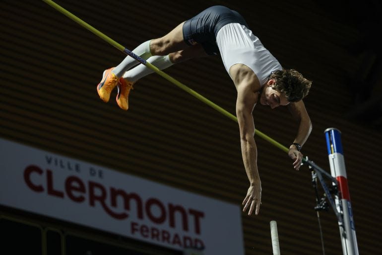 Swedish athlete Armand Duplantis clears the bar as he sets a new world record of 6,22 metres during the men's pole vault event of the International indoor athletics meeting.