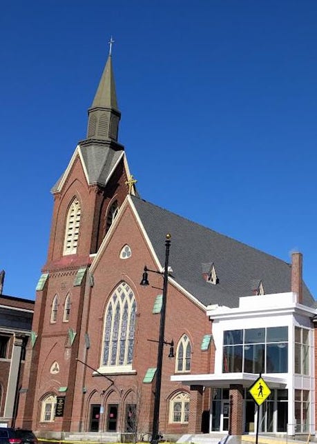 Picture of a brick church with a single steeple. Picture of a brick church with a single steeple.