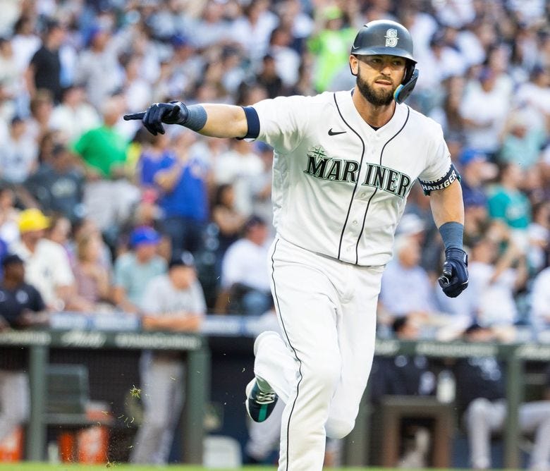 Mitch Haniger points to the dugout after homering against the New York Yankees in the first inning Monday in Seattle. (Dean Rutz / The Seattle Times)