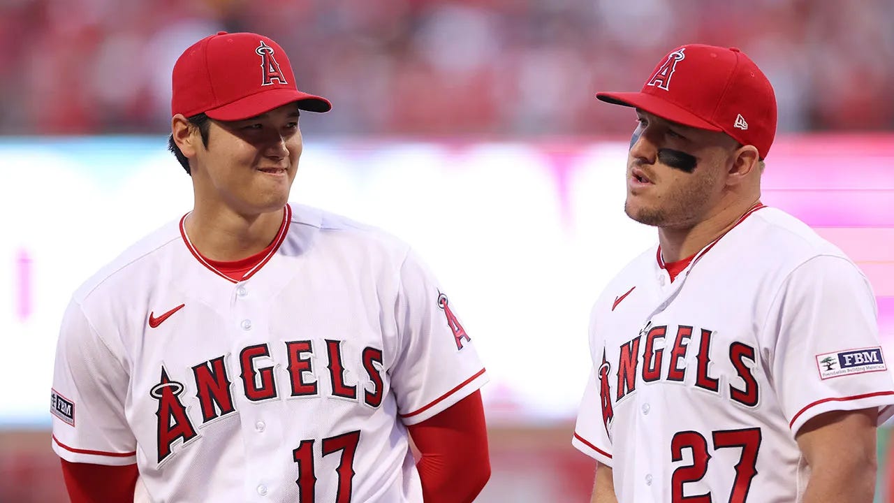 Ohtani and Trout smile at each other during an Angels game