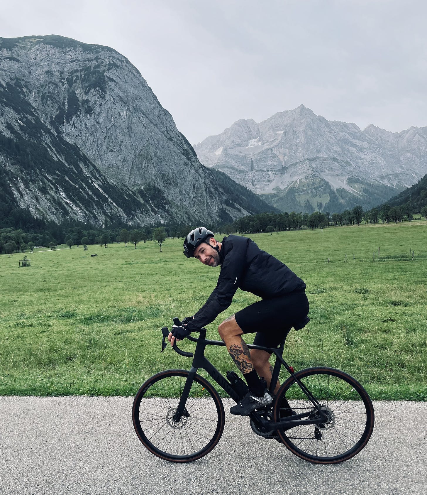 the author on a bike in front of a mountain range