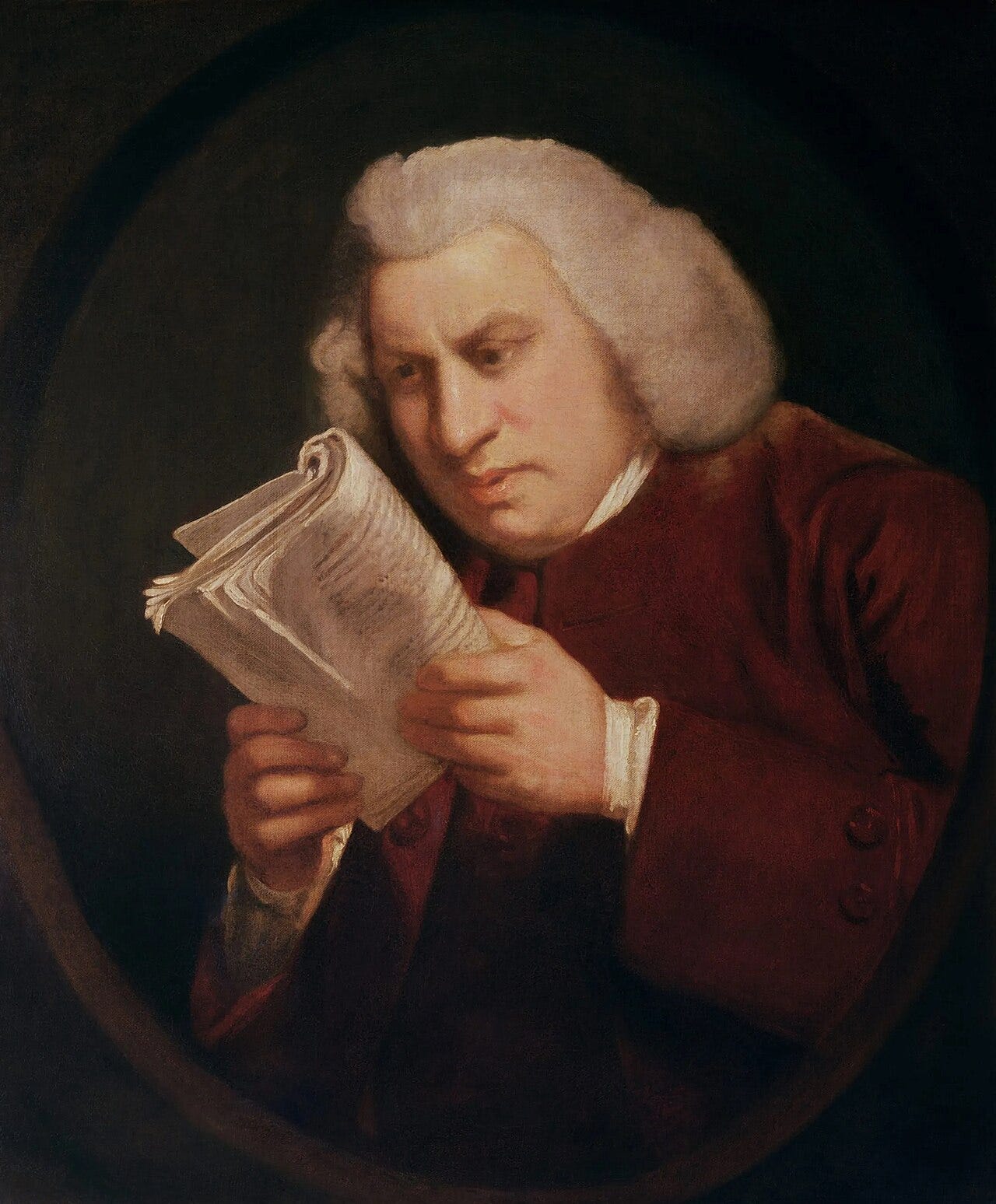 Man staring intently at a book held close to his face