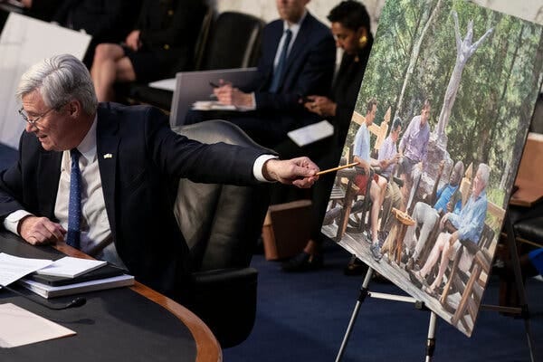 Senator Sheldon Whitehouse points to a photo of Justice Clarence Thomas during a hearing.