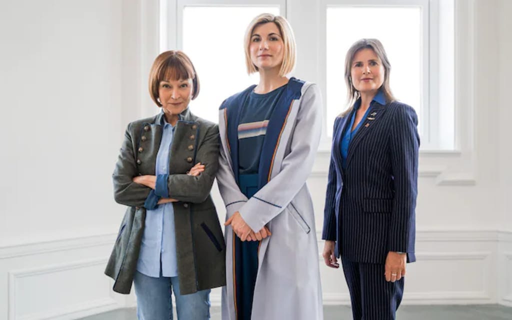 This promotional image shows, from left to right, Tegan Jovanka (played by Janet Fielding), the Thirteenth Doctor (played by Jodie Whittaker), and Dorothy "Ace" Gale (played by Sophie Aldred) as they appear in Doctor Who Series 13's ninth episode, "The Power of the Doctor." This promotional image shows, from left to right, Tegan Jovanka (played by Janet Fielding), the Thirteenth Doctor (played by Jodie Whittaker), and Dorothy "Ace" Gale (played by Sophie Aldred) as they appear in Doctor Who Series 13's ninth episode, "The Power of the Doctor."