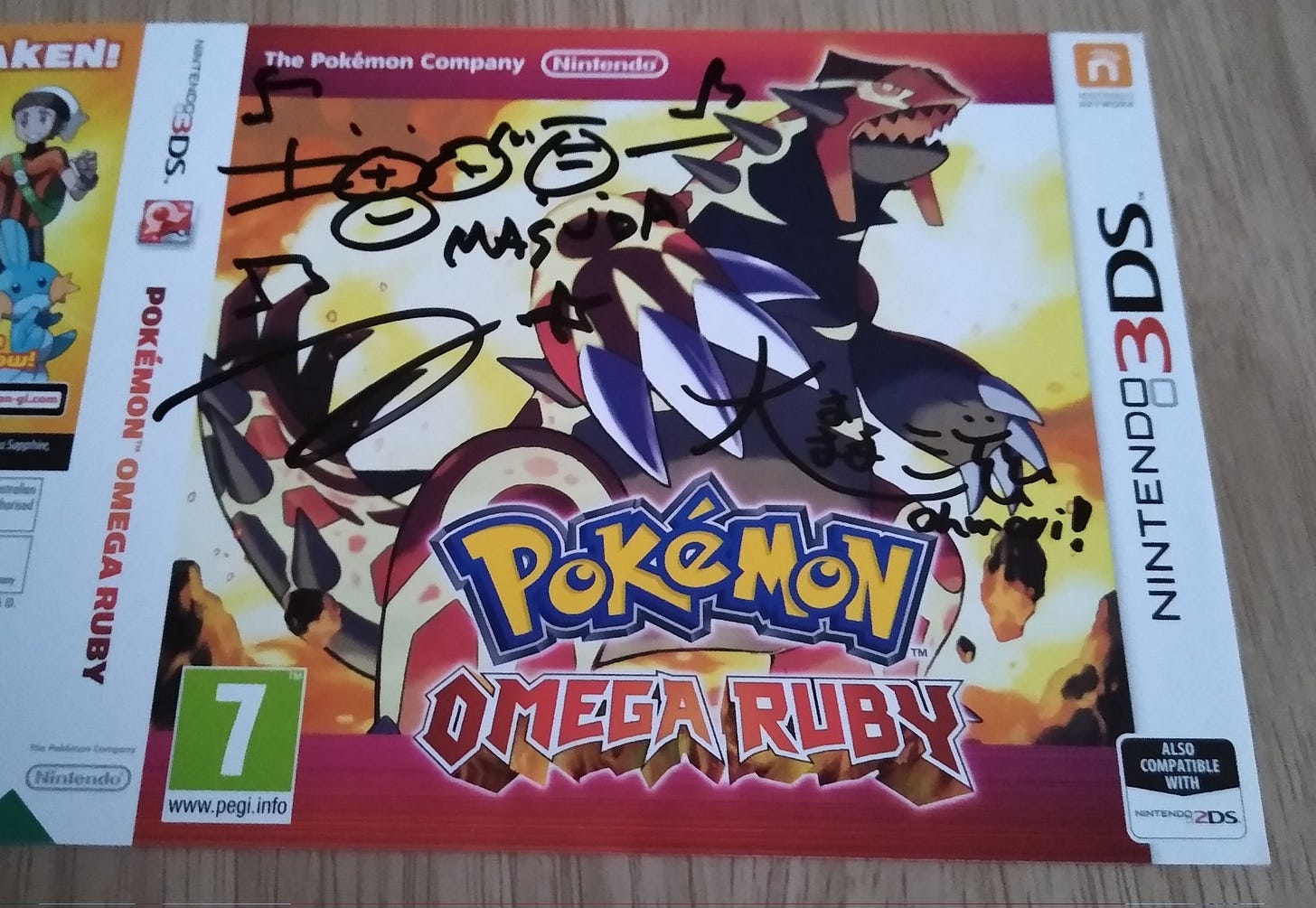 My Pokémon Omega Ruby cover, signed by Junichi Masuda and Shigeru Ohmori