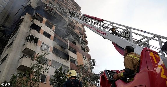 Firefighters work the scene of an explosion at a residence compound in northern Tehran, Iran, Friday, June 13, 2025. (AP Photo/Vahid Salemi)