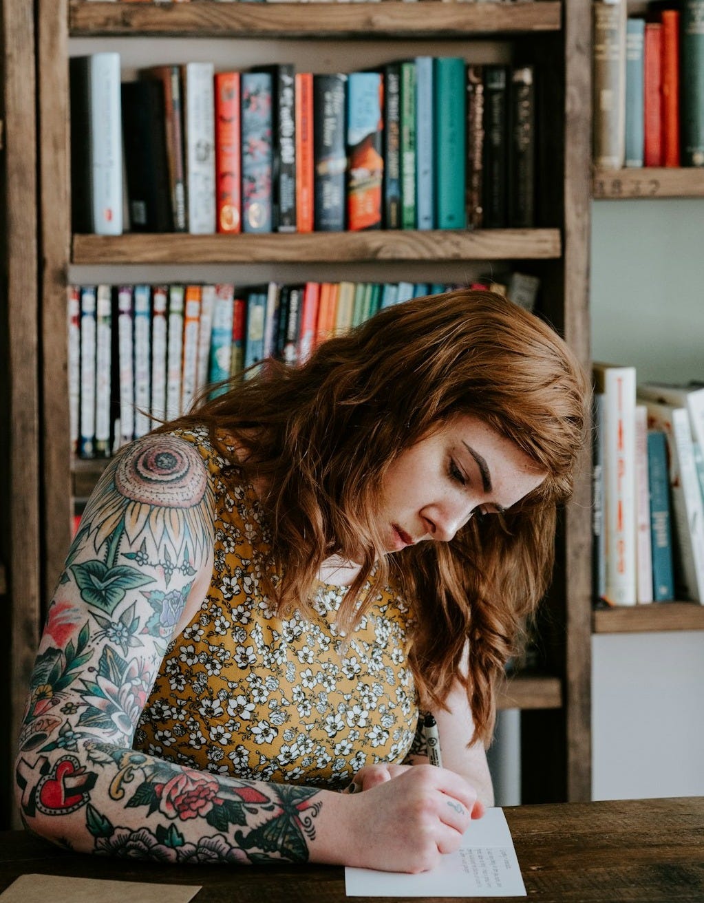 woman writing on white paper woman writing on white paper
