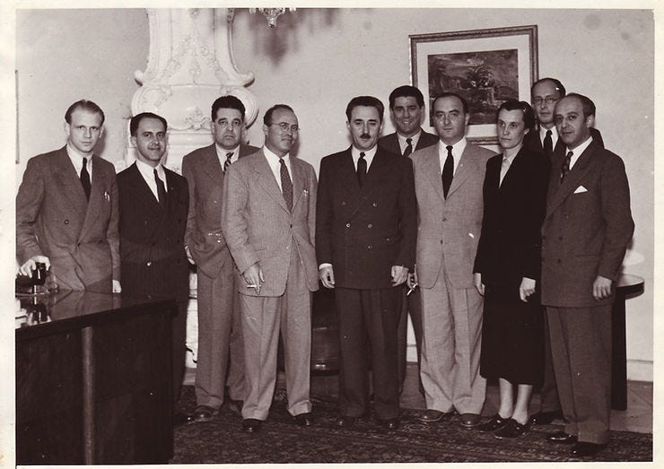 Photo of Foreign Ministry taken in Prague, between 1949–53 of possible members of the original Mossad as we know it today. On left is Rafi Friedl hero of Slovak Jewish underground in Budapest), The third person from the left was a “cipher clerk” (Yosef Bernstein - Eilom) at the embassy middle is Reuven Shiloah (head of the Mossad), in middle is Moshe Sharett (Shertok) and to his right in back is Zalman and to the far right is Ehud Avriel.  In back right, behind two people is Michael Hutter.    Source: Martin Šmok, Curator, postwar segments of new permanent exhibition for the Spanish synagogue at Jewish Museum in Prague