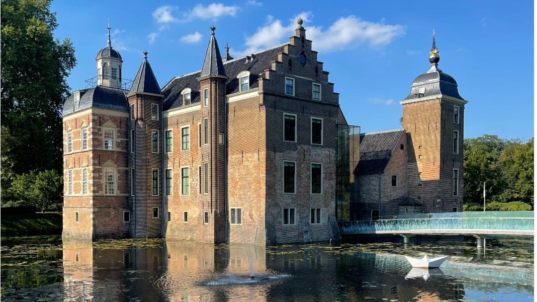 A classic castle with high walls surrounded by water.