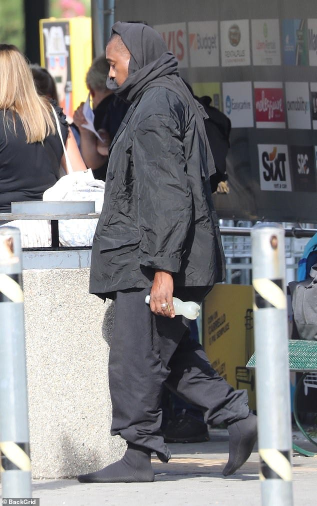 There he is: Kanye was seen walking in just socks on the outing