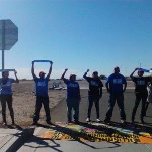 Immigration rights advocates blockade the Eloy Immigration Detention Center. (Photo credit: National Day Labor Organization)