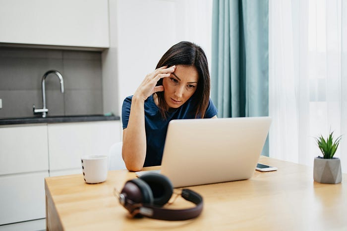 A woman frustrated by online comments. A woman frustrated by online comments.