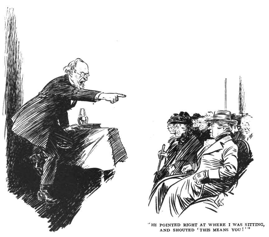 Mr Mundy, a balding man with floppy white hair and a short straight beard on his chin, is standing by a table on stage as he points accusingly at the audience. The audience is largely comprised of older women. The caption reads, ""He pointed right at where I was sitting, and shouted 'This means you!'"