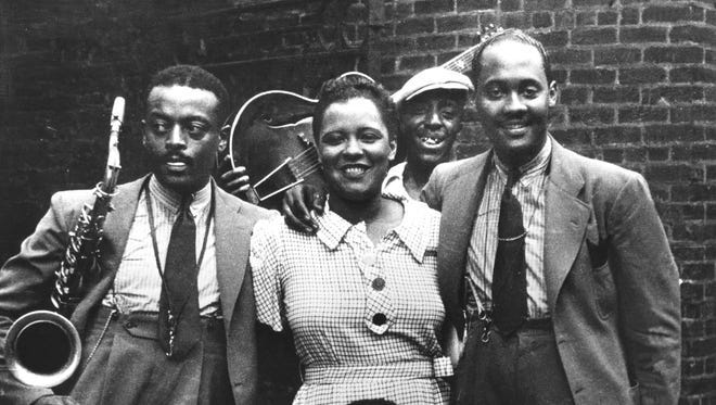 Legendary singer Billie Holiday with musicians including Ben Webster, left, and Johnny Russell, right, in Harlem in 1935.
