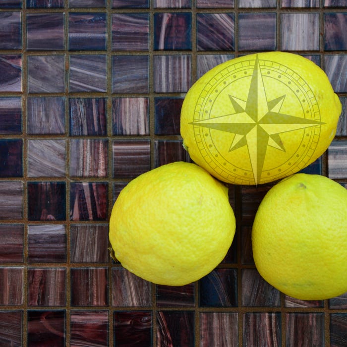 dark mosaic background with 3 lemons on right. Top lemon has a graphic of a navigation symbol (compass).