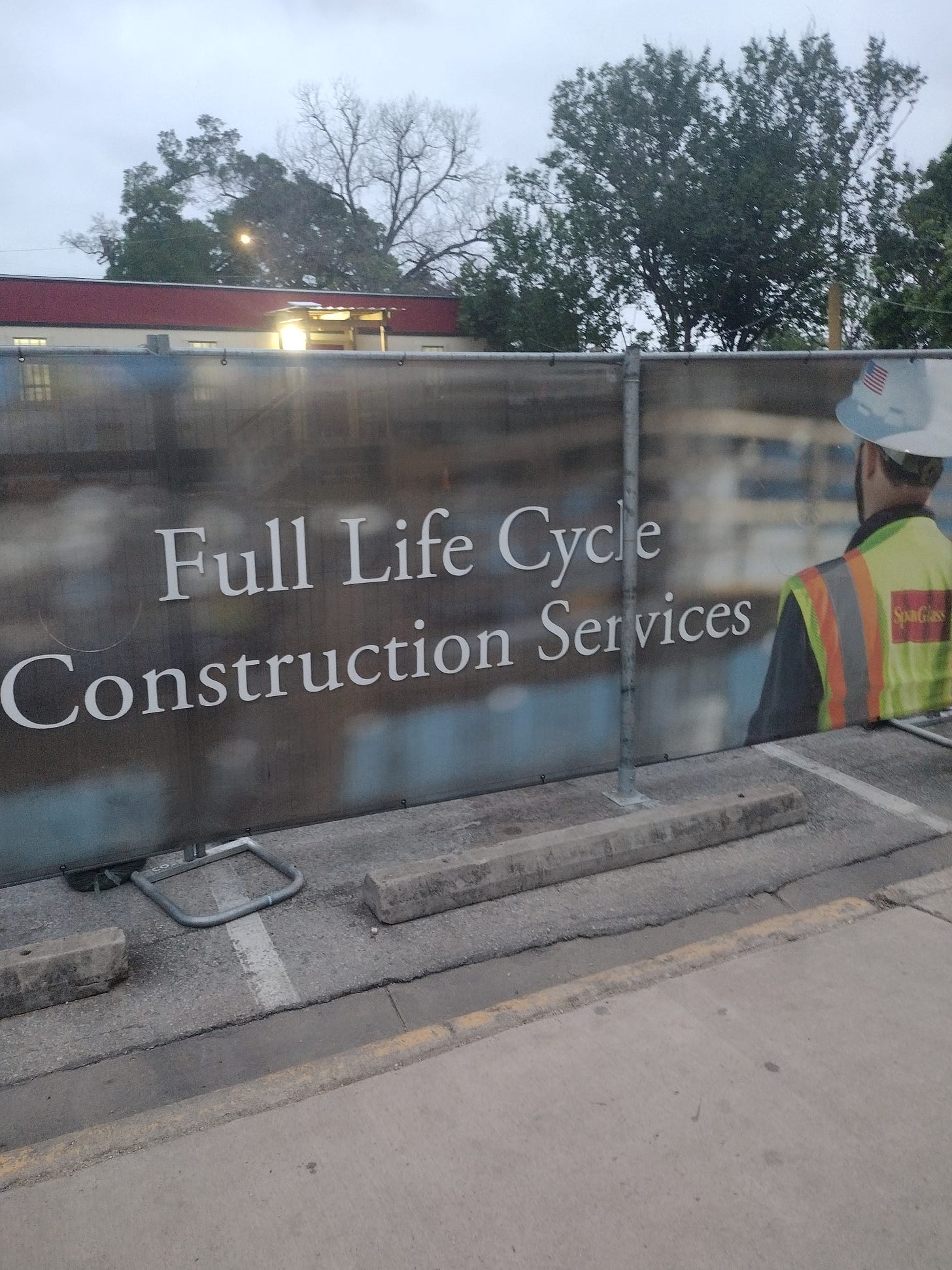 Large banner with picture of man in hard hat; banner reads Full Life Cycle Construction Services