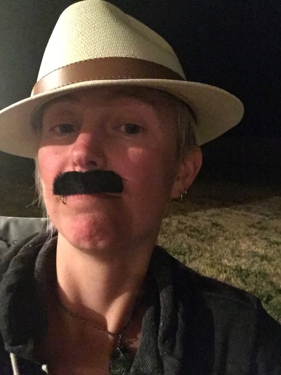 Jessie wearing a straw hat and fake mustache. She is almost certainly whisky-tipsy in this photo.