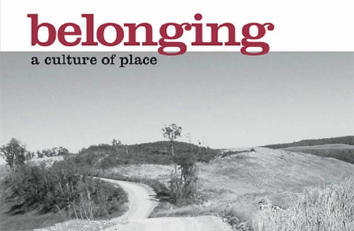Cover snippet from Belonging: A Culture of Place by bell hooks. Gray-toned photo of dirt road in gently rolling hills.