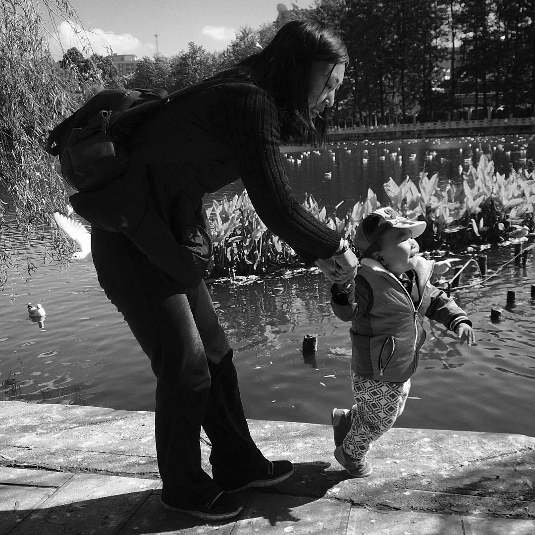 Mother and child at Green Lake Park in Kunming, the capital and largest city of Yunnan Province.