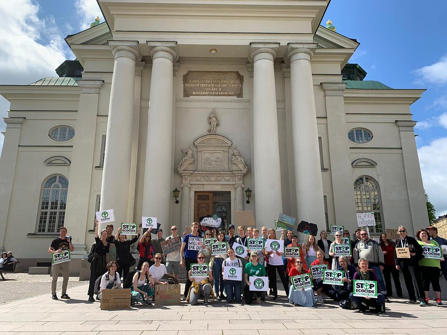 Protestors holding “Stop Ecocide” placards at Stockholm+50.