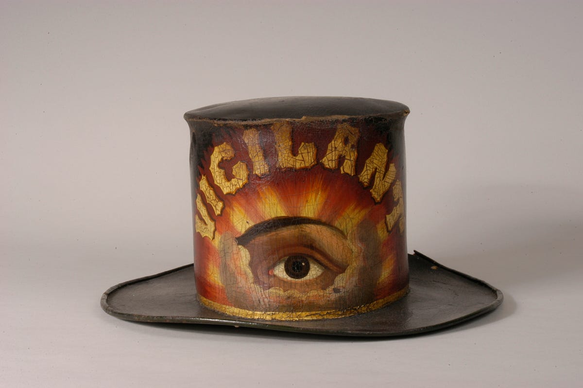 painted leather fire hat -- showing an eye in the clouds with the word vigilant in gold painted leather fire hat -- showing an eye in the clouds with the word vigilant in gold