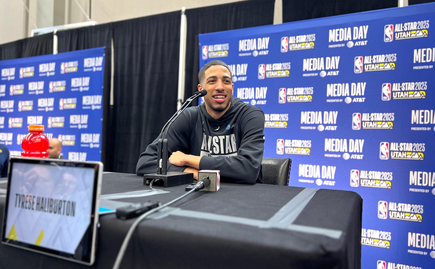 Pacers guard Tyrese Haliburton sits at a podium in Salt Lake City to talk with reporters before the NBA All-Star game.